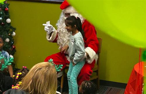 Smiling child on Santa's lap.